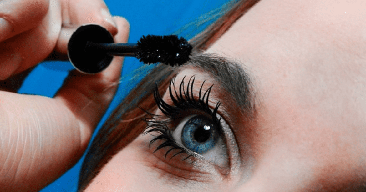 This image shows a lady using the Lash Serum