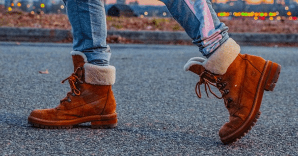 A man wearing a hiking boots with jeans